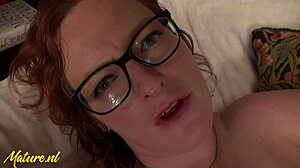 Scantily clad latina milf KD Morgan with glasses gives a close up view of her touching her bare twat