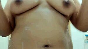 Sensual Filipina showers soaping big boobs in homemade video.