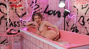 Anita relaxes in pink bath with lingerie
