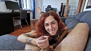 Redhead swallows cum in mouth during pov blowjob with feet up.