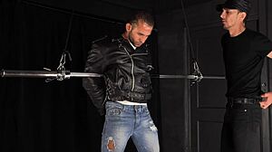 Muscle hunk gets tied up and teased in gay BDSM scene