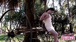 Nina shows sexy body and rubs pussy outdoors