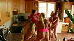 German mommy enjoys group sex with strangers, big tits on display.