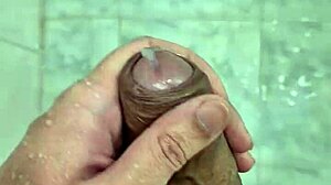 Young Brazilian guy masturbates in the shower until he cums.