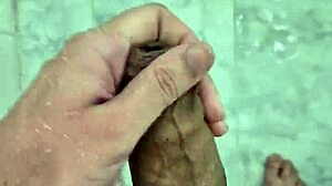 Young Brazilian guy masturbates in the shower until he cums.