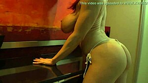 Muscular redhead in tiny bikini