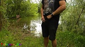 Hey, this gay amateur is jerking his monster cock by the lake and fingering his tight hole