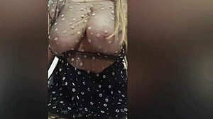 Busty beauty in black shows off big tits with stunning charm.