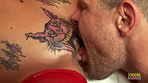 Skinny blonde with a pussy tattoo gets a creampie on a red couch