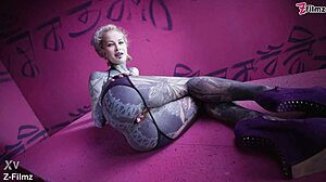 Tattoo goth punk babe fingers solo, showing off anal gapes with buttplug collection