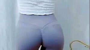 the young asian girl dances in the room, showing off her cameltoe