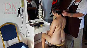 At the nude barbershop, the hairdresser convinces a curvy lady to undress for a wild haircut scene.