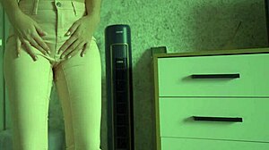 Female desperate to pee wets her jeans and panties.