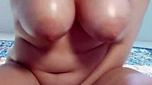 Oiled up chubby babe riding hard with big natural tits bouncing.