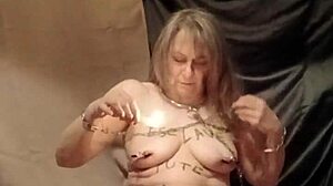 Slave endures self-bondage and wax play outdoors