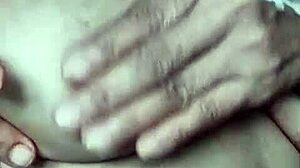 A mature wife showcases her breasts in an intimate, sensual scene