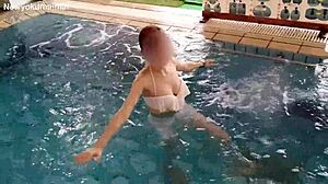 Stunning brunette works out solo in pool with sexy moves!