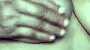 A mature wife showcases her breasts in an intimate, sensual scene