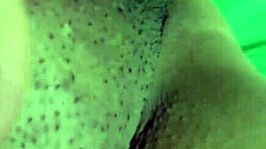 alone at home, she indulges in some private masturbation with her shaved pussy