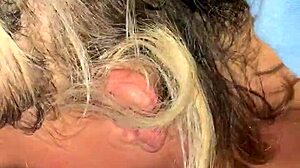 Mature blonde engages in deepthroat with big black cock