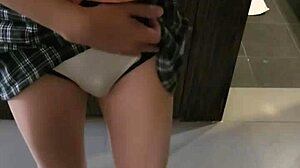 Shemale ladyboy seductively poses and flirts before the mirror.