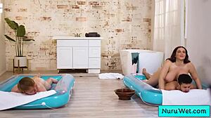 Sexy busty masseuse handles two clients!