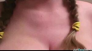 Pigtailed brunette playing with her big tits