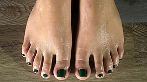 Cleaning her feet with damp cloth and showing green fingernails close-up