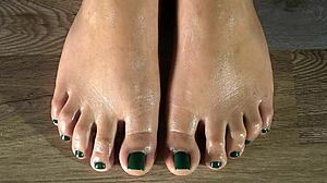 Cleaning her feet with damp cloth and showing green fingernails close-up