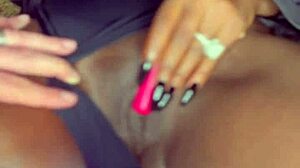 Sexy black model uses vibrator on wet shaved pussy