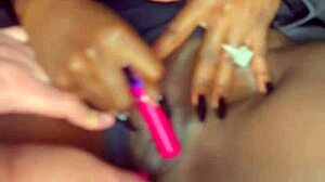 Sexy black model uses vibrator on wet shaved pussy