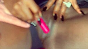 Sexy black model uses vibrator on wet shaved pussy