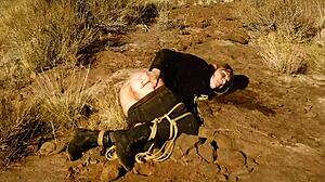 Rebel Rhyder's asshole gets whipped before rough anal in dirt and piss outdoors in western USA.