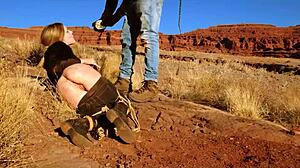 Rebel Rhyder's asshole gets whipped before rough anal in dirt and piss outdoors in western USA.