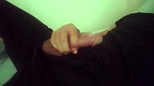 horny guy moans while jerking his huge cock in bedroom after work, cumming hard